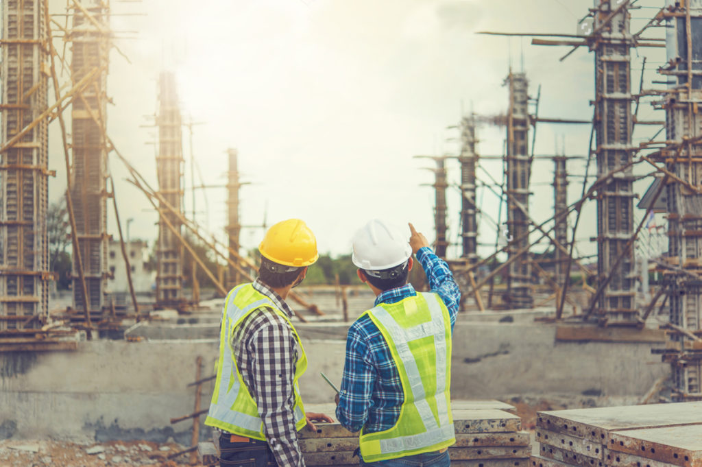 stock-photo-two-young-man-architect-on-a-building-construction-site-655639096-1024x681