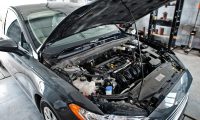 Car repair and maintenance theme. Car open hood engine in auto service.